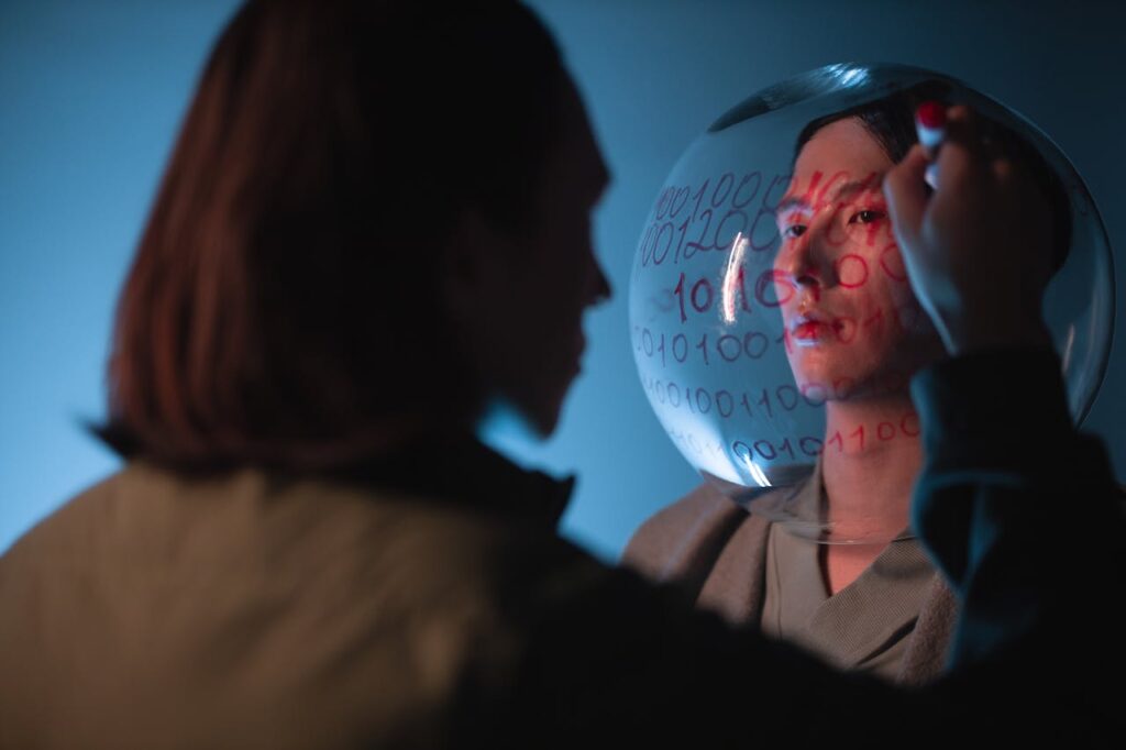 Artistic photo of a person reflecting on binary code on a transparent surface.